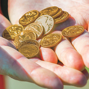Image of hands holding gold coins