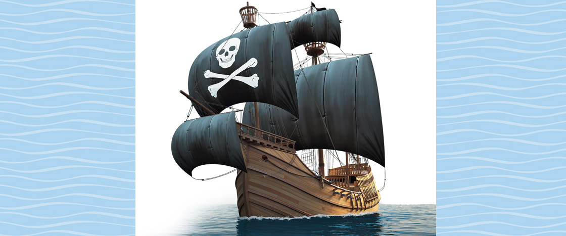 Image of a sailing pirate ship with skull and crossbones on the sails