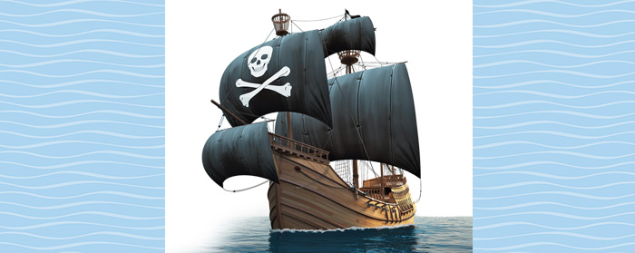 Image of a sailing pirate ship with skull and crossbones on the sails