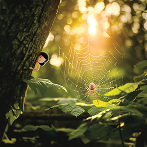 Image of a kid shrunk down and watching a spider