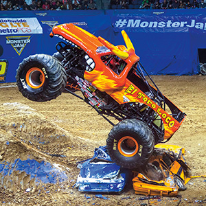 Image of a monster truck crushing two cars